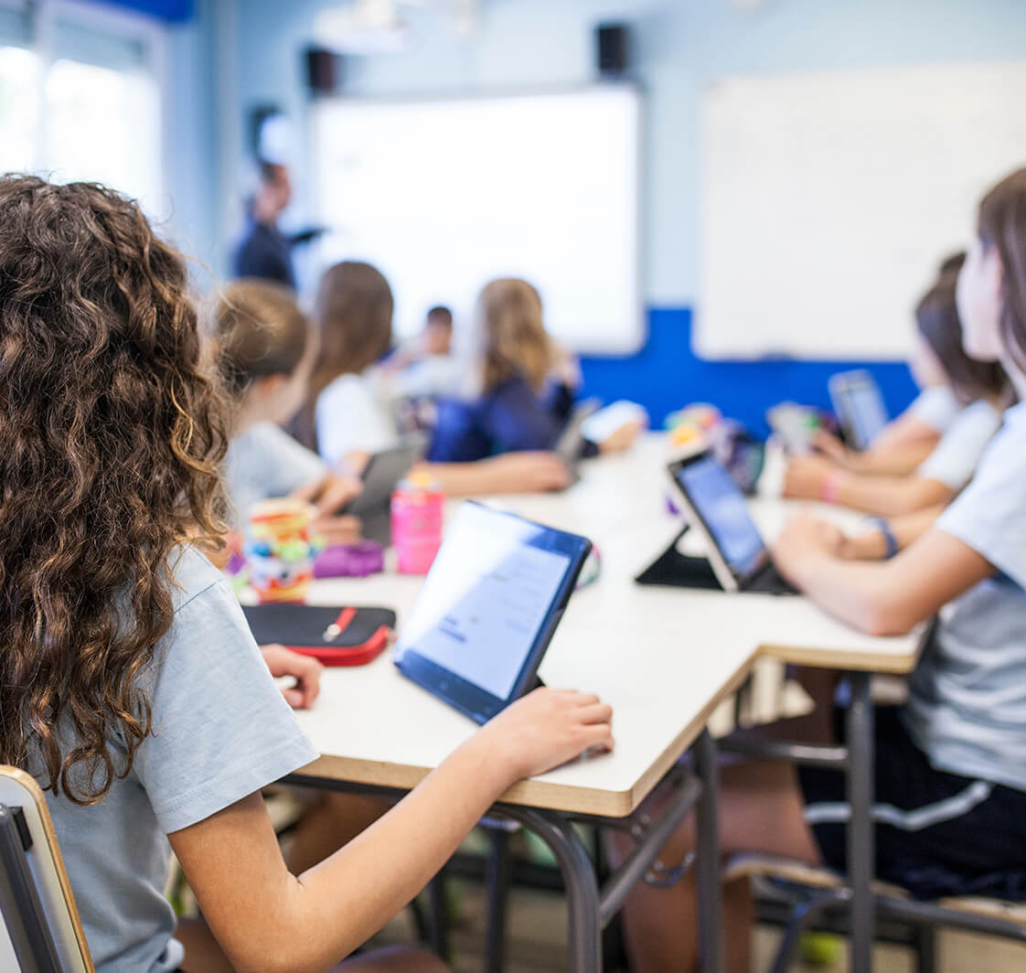 Children using technology in a classroom.