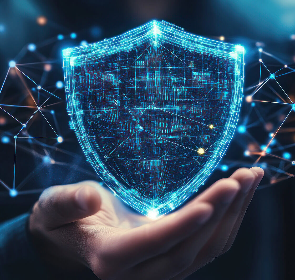 A glowing digital shield held in a hand, symbolizing cybersecurity and protection.