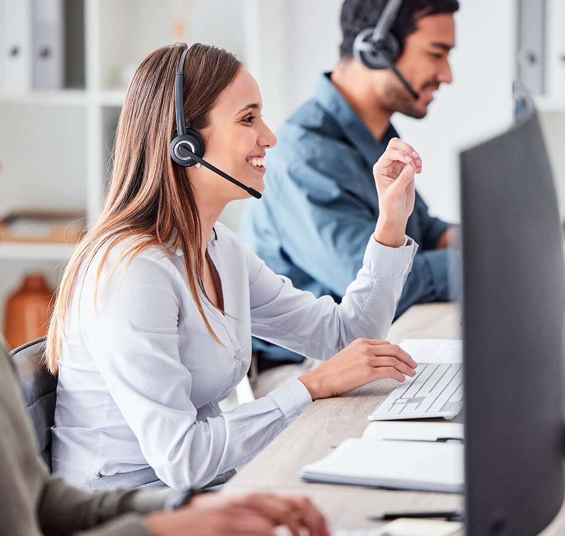 Call center, woman and working in team office with headset, computer and online customer support, service or help.