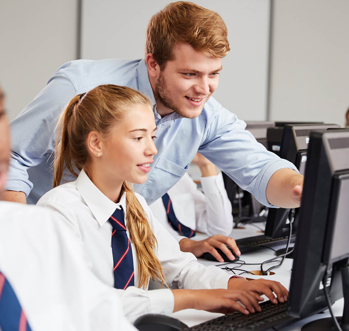 Teacher and students using a computer.