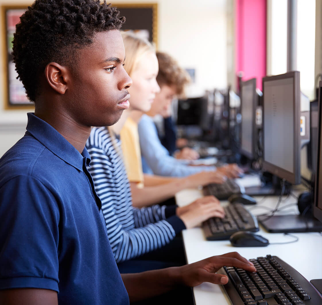 School children using compuers in a classroom.