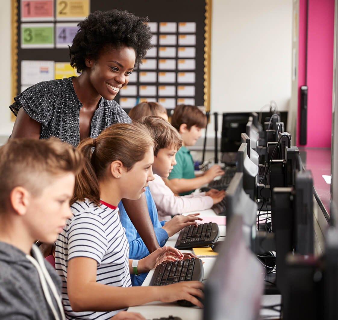 Children using computers in a classroom.