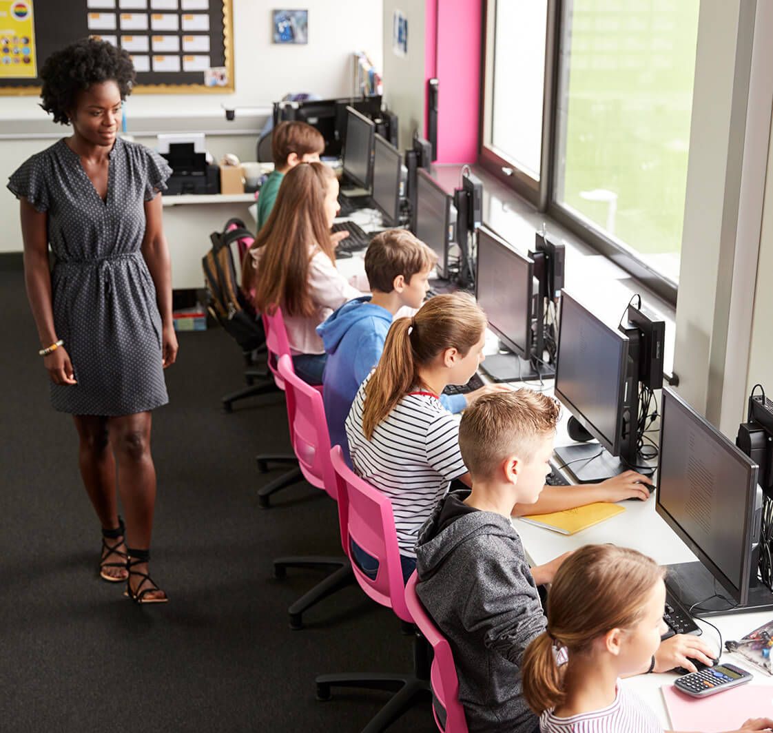 Children using computers in a classroom.