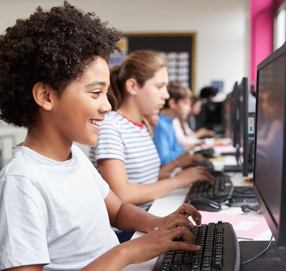 Children using computers in a school classroom.