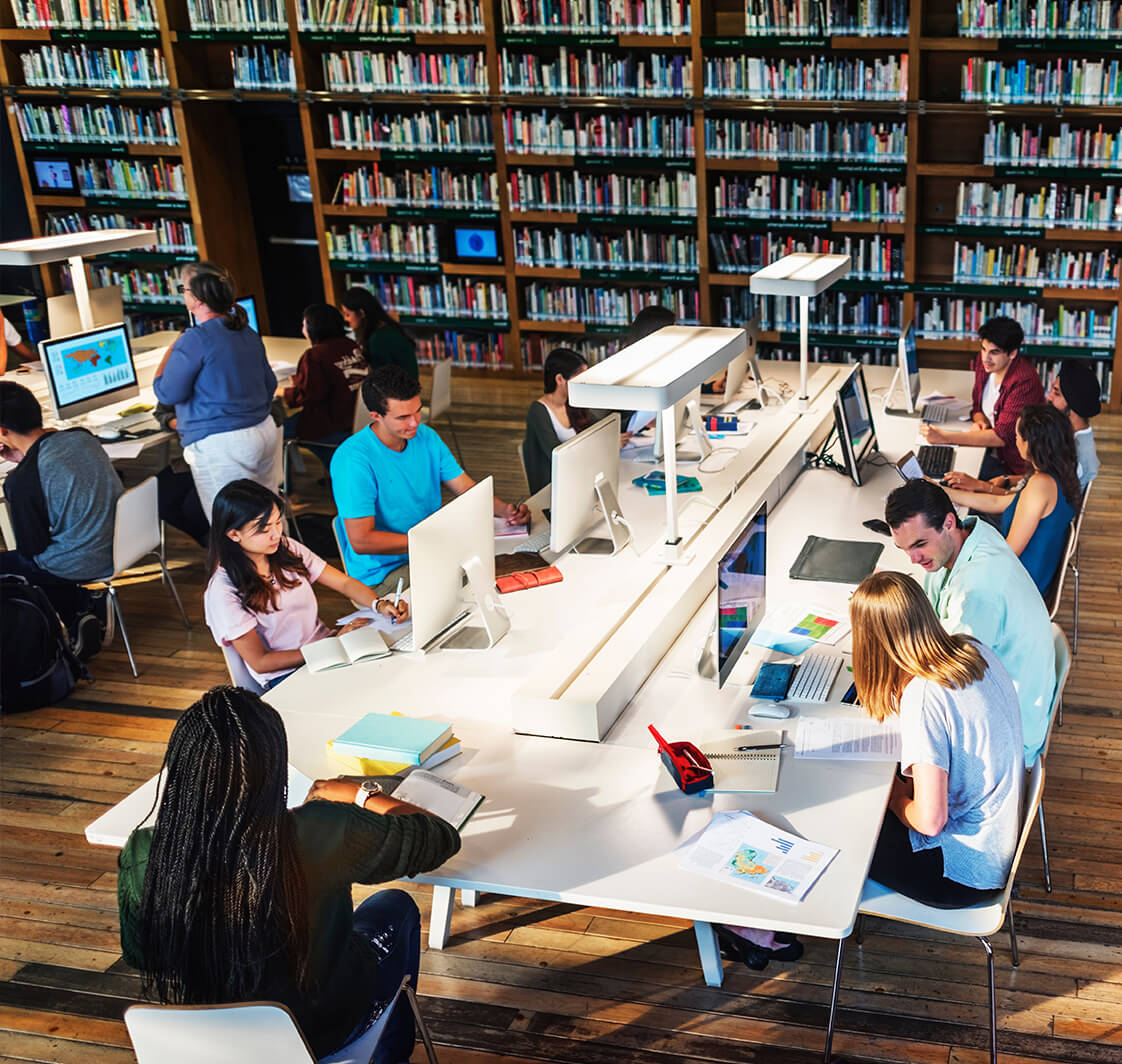 Sixth form students using computers in a school library.