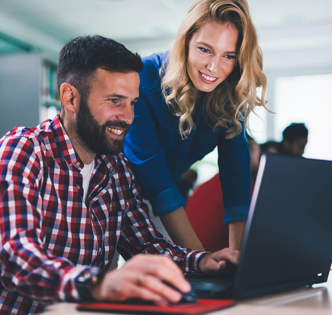 Man and a woman looking at a laptop.