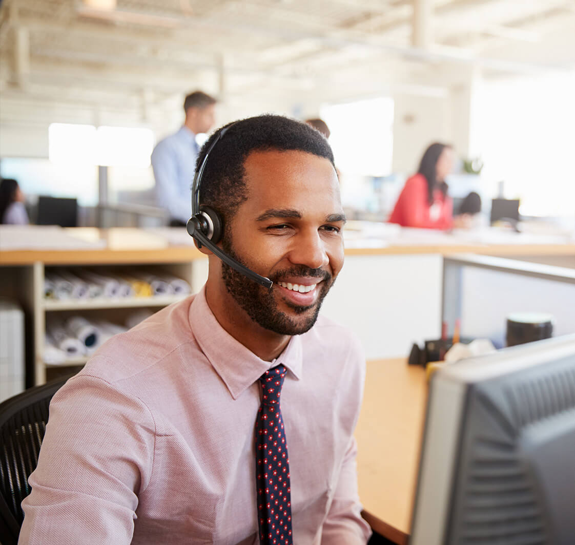 Support team memeber speaking to a customer with a headset on.