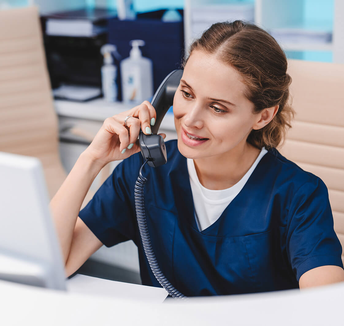 Nurse speaking on a phone.