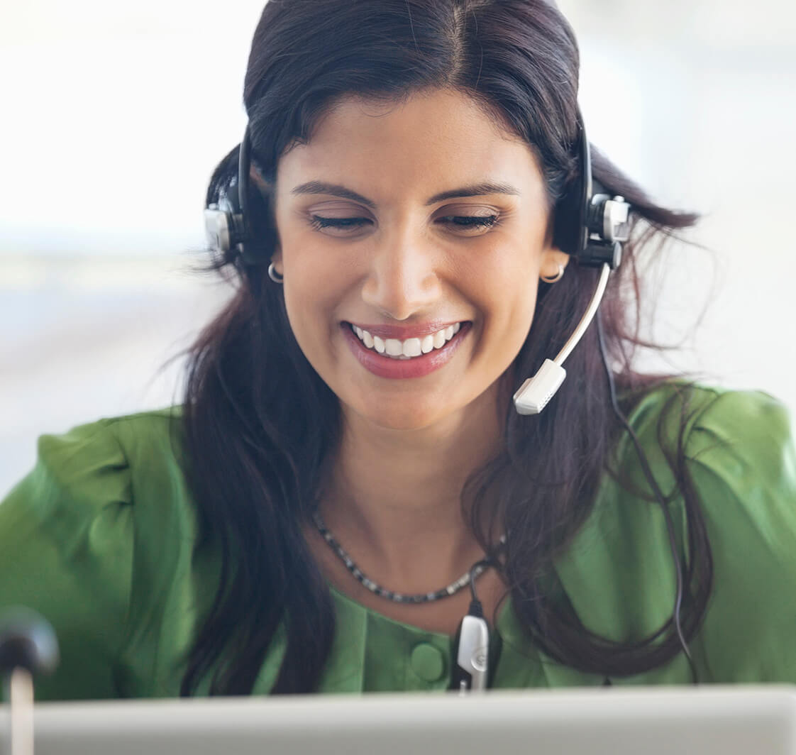 Woman wearing headset at desk.