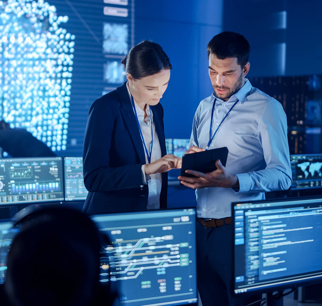 Project Manager and Computer Science Engineer Talking while Using A Digital Tablet Computer.