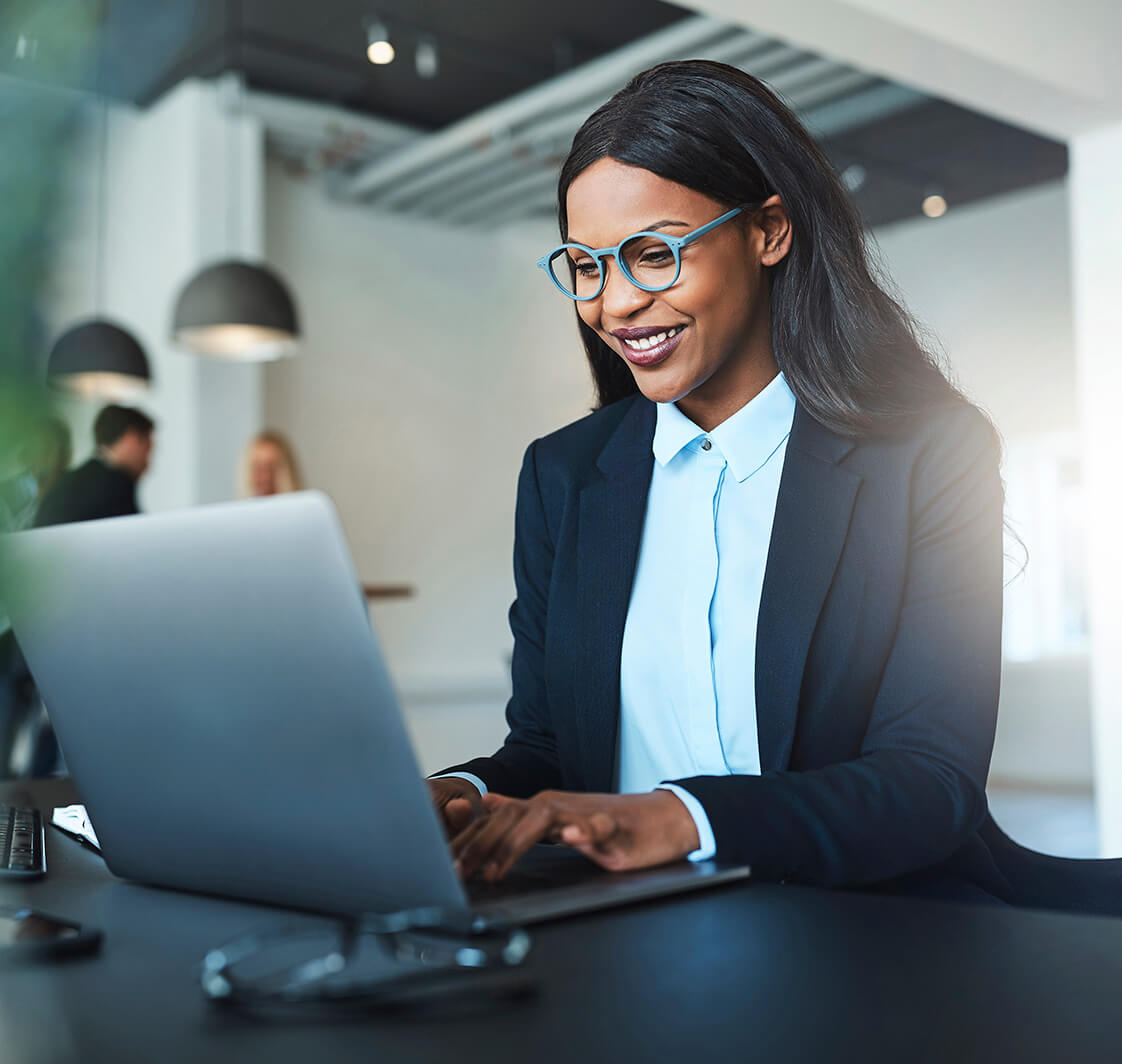 Young professional businesswoman using a laptop.