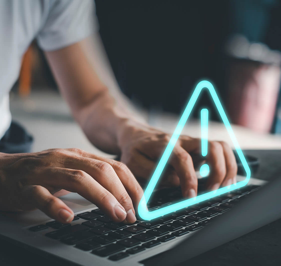 Businessman using computer laptop with triangle caution warning sing for notification error and maintenance concept