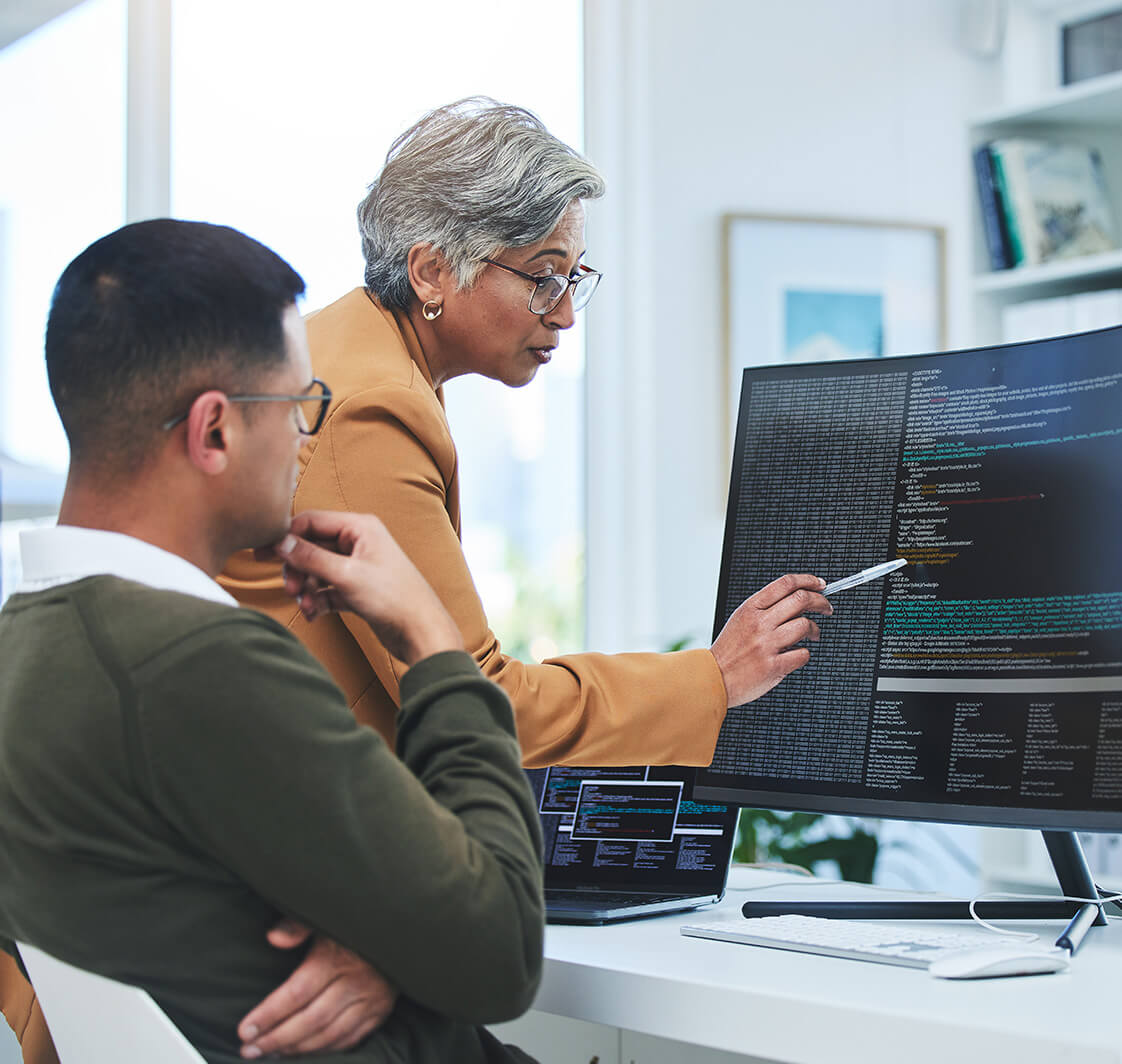 Coaching, mentor and programmer with business people and computer for coding, developer or information technology. Meeting, code review and feedback with employees in digital agency for cybersecurity.
