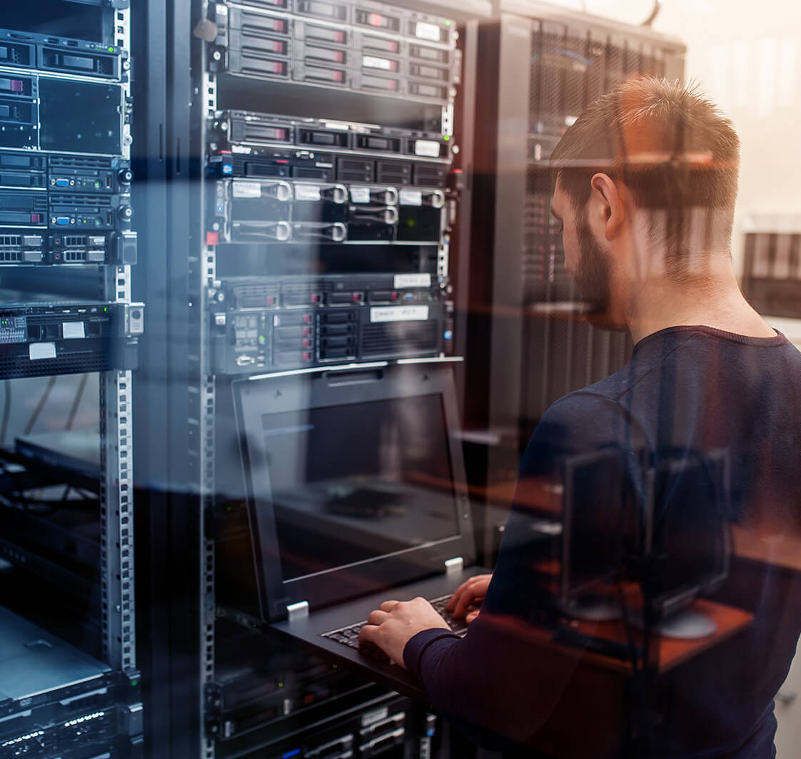 Network engineer working in server room.