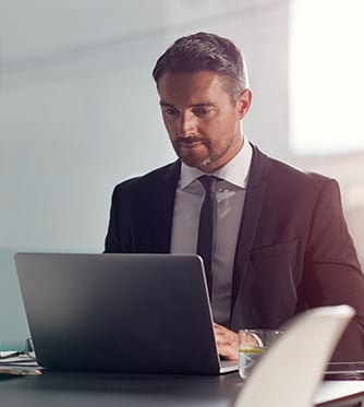 Business man in office for career planning, project review and company management software. Professional person typing, focus and online analysis on computer in conference room.