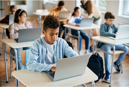 Students using Microsoft 365 on laptops