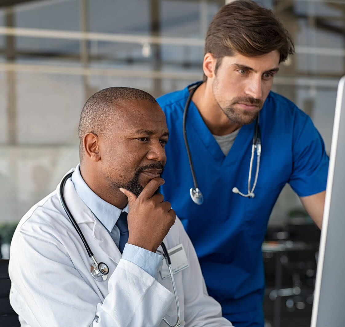 Doctor consulting patient medical record with nurse.