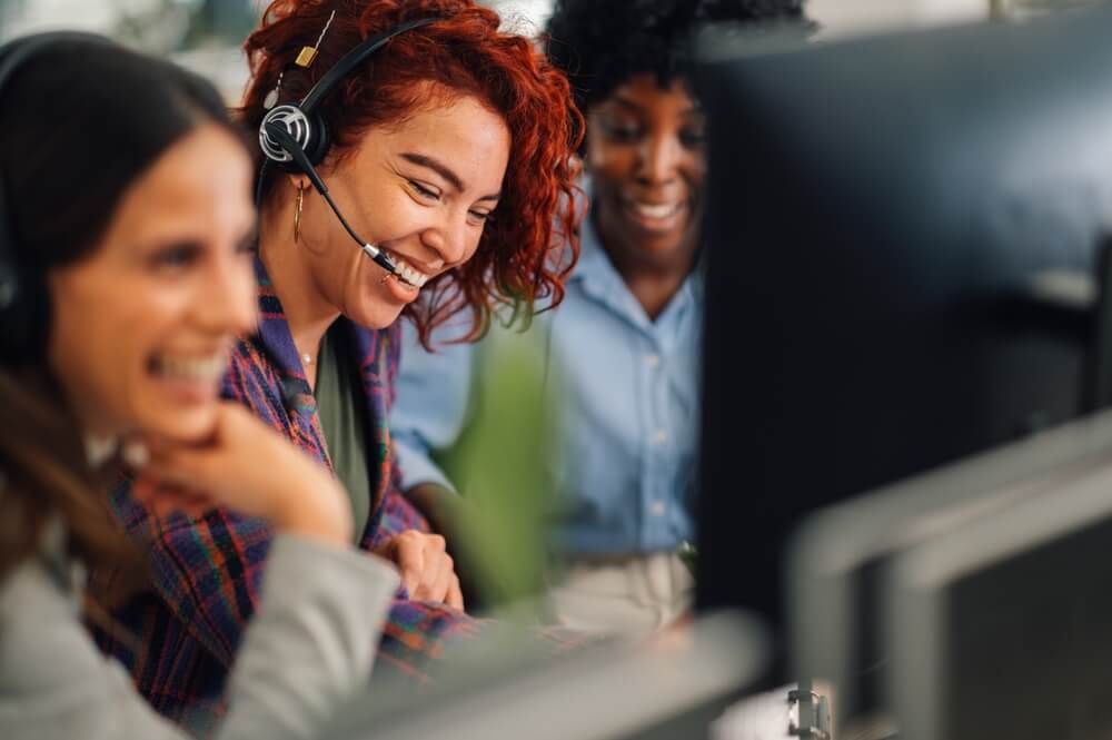 Happy telephone operators showcasing the success of a University's improved communication with a new telephony system