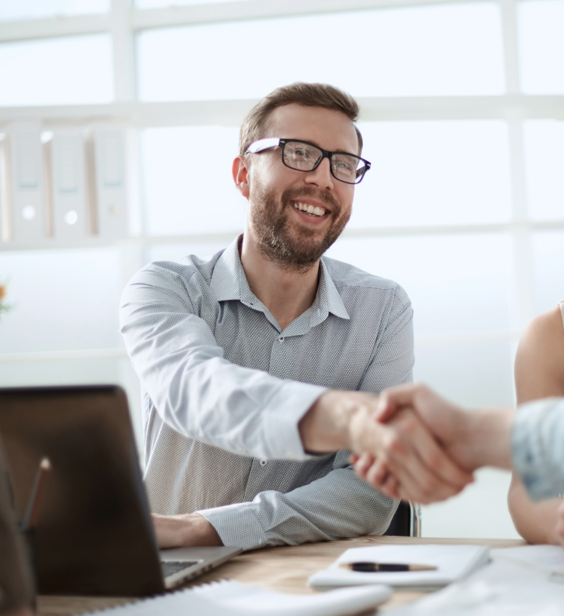 Male worker shaking hands and smiling with a colleage/customer