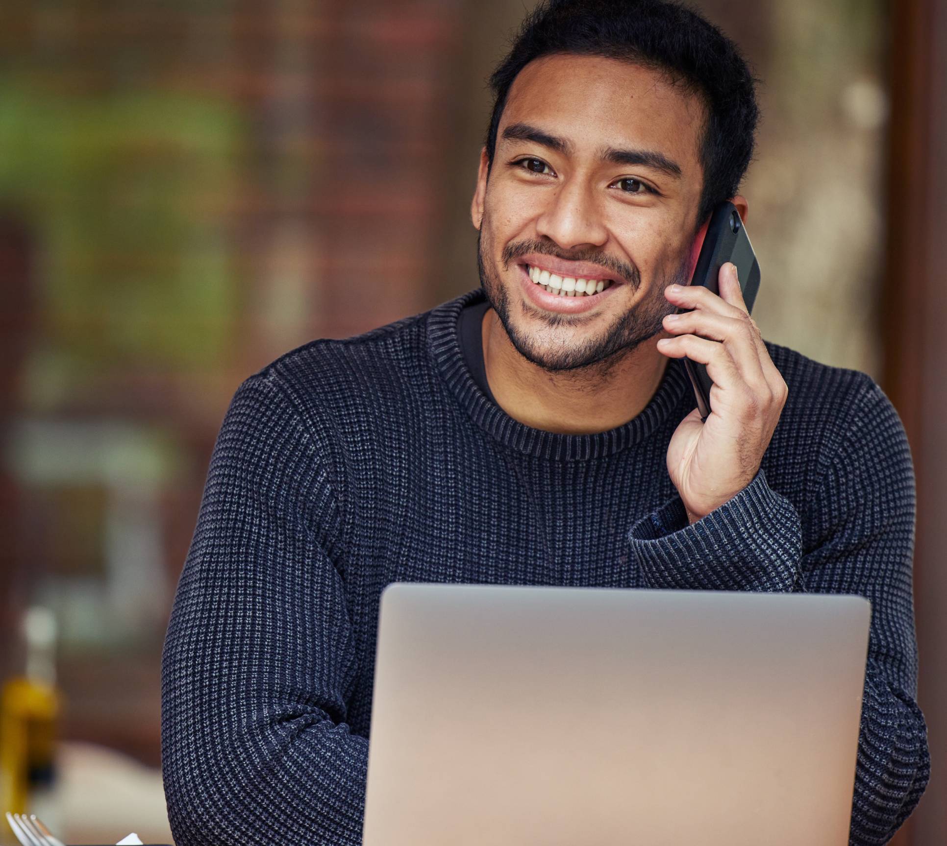 Man on laptop and phone