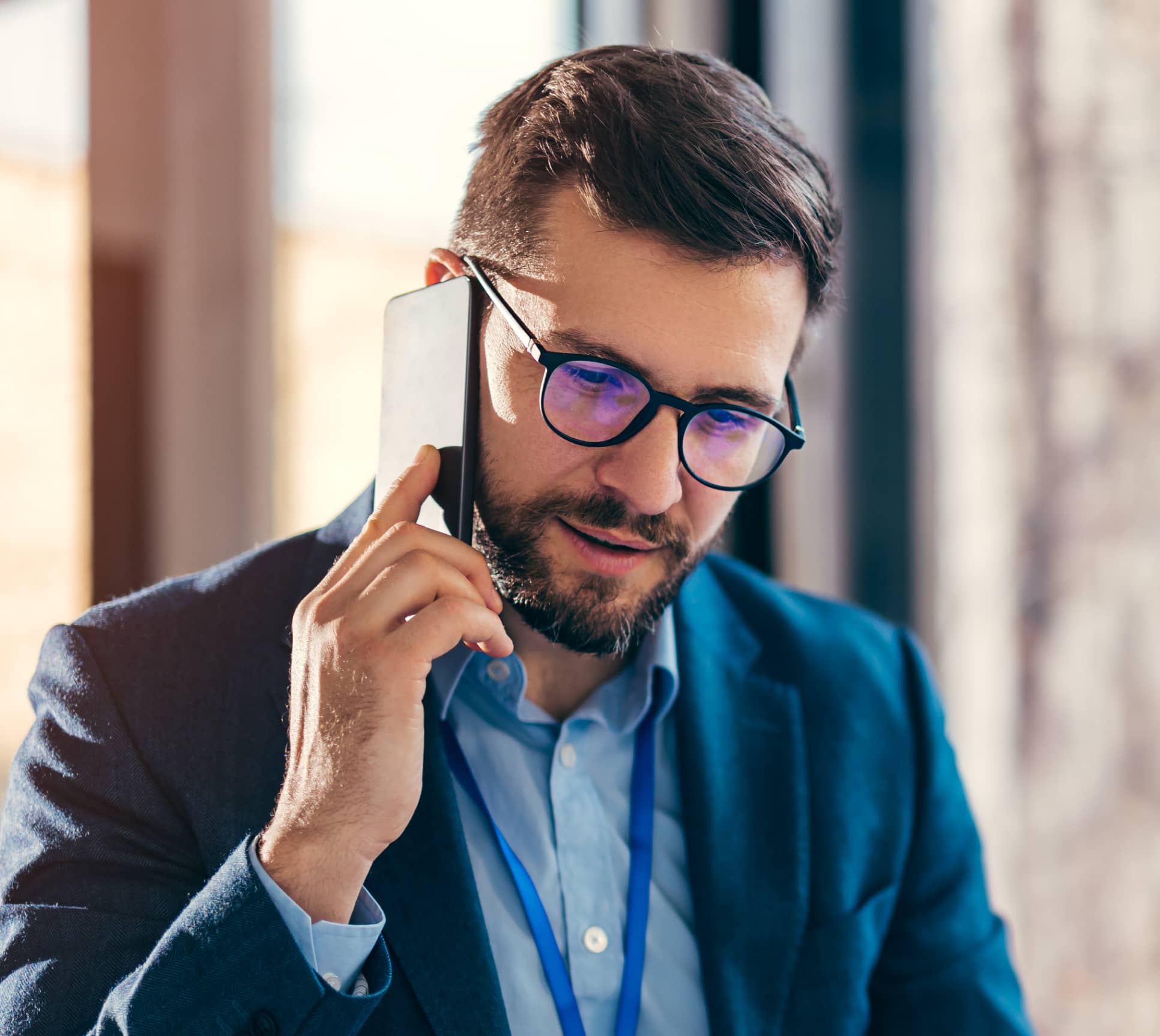 Male worker in suit on mobile phone