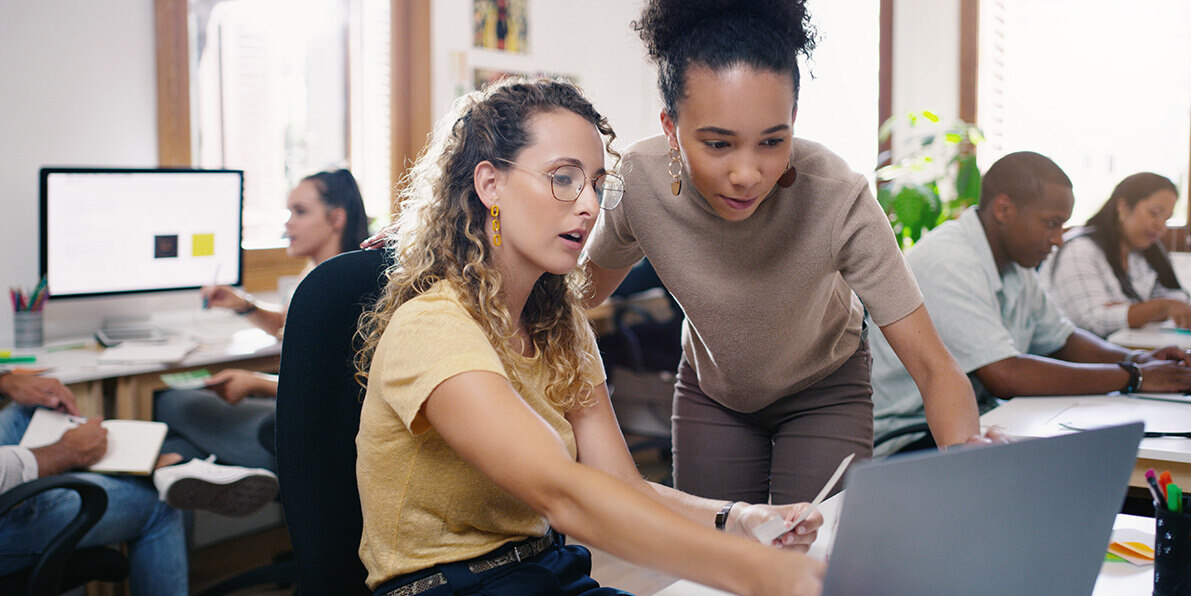People working in a busy office using IT