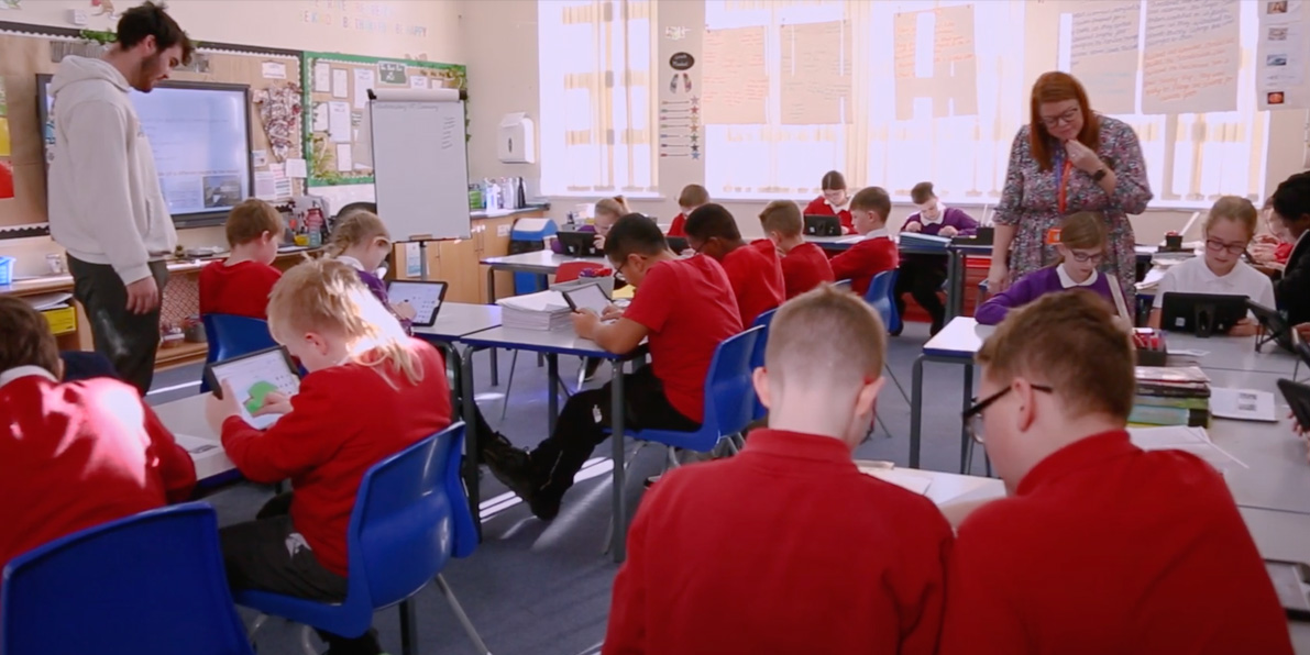 School Classrrom with children working on devices connected to WiFi